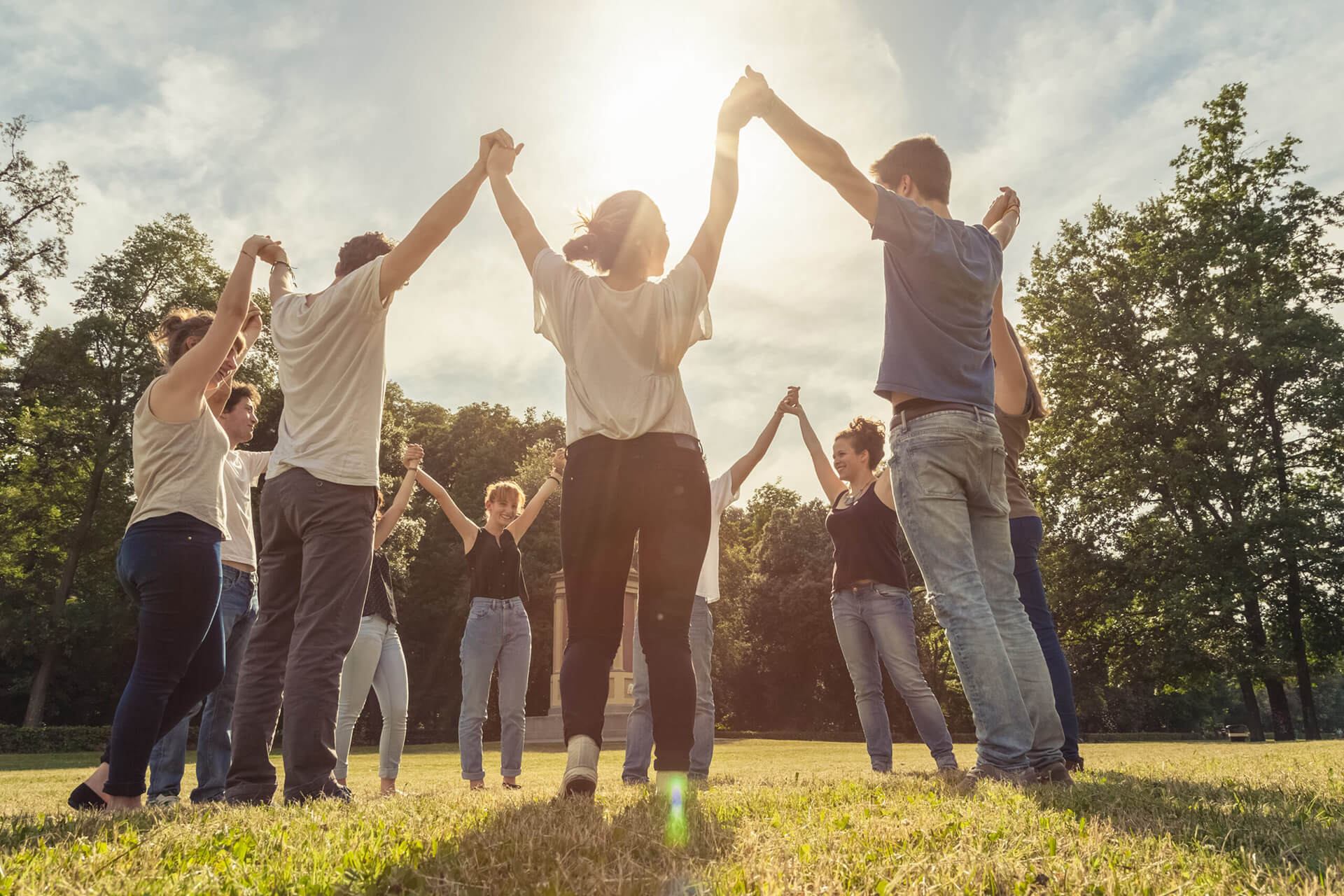 A Group of People of Various Ethnicities Holding Hands and Raising Their Arms in Celebration